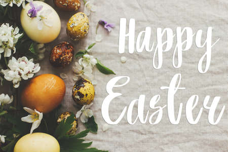 Happy Easter greeting card. Happy Easter text sign handwritten on  modern yellow easter eggs with...