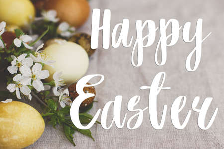 Happy Easter greeting card. Happy Easter text sign handwritten on  modern yellow easter eggs with...