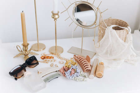 Modern summer accessories. Golden jewellery, sunglasses, hair clips, cosmetics, perfume and lace...