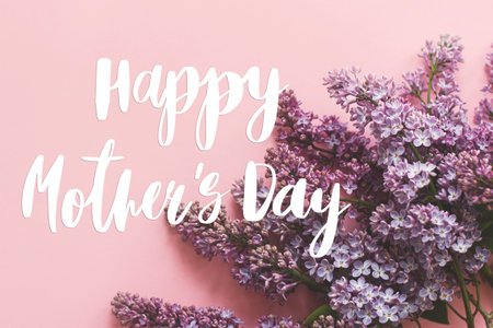 Happy mother's day. Happy mother's day text and lilac flowers on pink paper. Stylish floral greeting card. Handwritten lettering on purple lilac branch on pink. Mothers dayの写真素材
