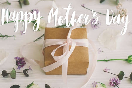 Happy mother's day greeting card. Happy mother's day text and gift box, lilac, roses flowers and...