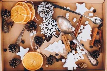 Christmas wooden decorations, anise star, cinnamon, dried oranges, pine cones, spoons, marshmallow...
