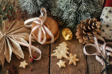 Christmas cookies and festive decorations on rustic wooden table. Atmospheric stylish christmas...