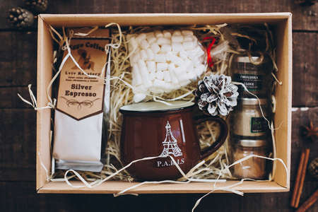 Lviv, Ukraine - December 1, 2017: Roasted Coffee, marshmallow, cup and spices on straw in gift box...