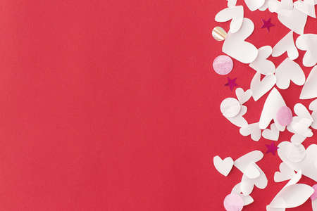 Happy Valentine's Day! Stylish hearts border on red background flat lay with space for text....