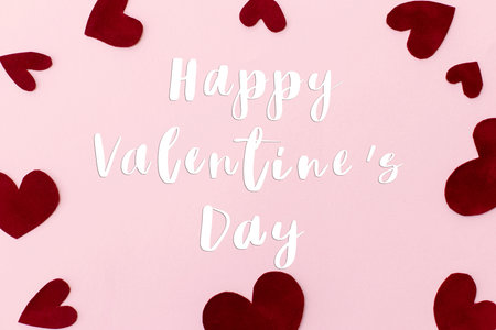 Happy Valentine's Day text on stylish red hearts on pink background, flat lay. Happy Valentines Day greeting card. Be my Valentine. Love conceptの写真素材