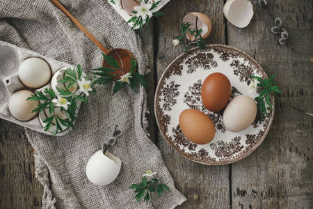 Easter rustic still life. Natural easter eggs, blooming spring flowers, burlap and spoon  flat lay...