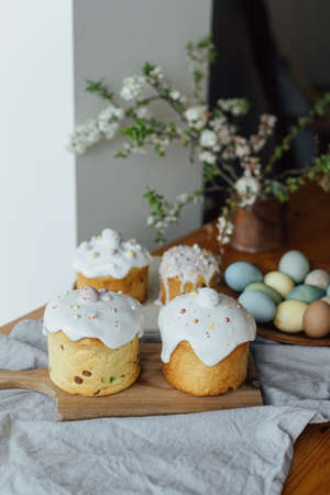 Happy Easter!  Homemade easter bread, natural dyed eggs and spring blossom on rustic table in room....