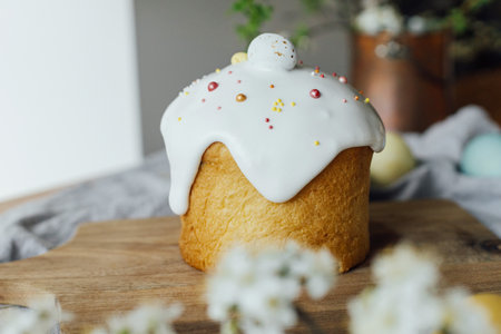 Homemade easter bread, natural dyed eggs and spring blossom on rustic table in room. Happy Easter!...