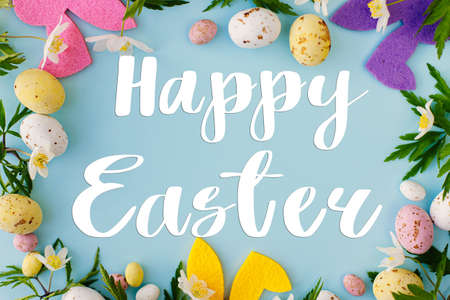 Happy Easter greeting card. Happy Easter text and colorful bunnies, chocolate eggs and spring...