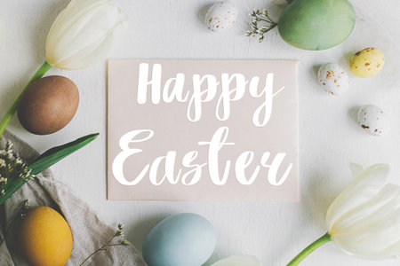 Happy Easter greeting card. Happy Easter text and greeting card, stylish Easter eggs and tulips on...