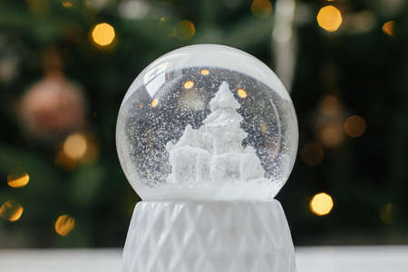 Merry Christmas! Atmospheric winter time. Stylish christmas snow globe on background of christmas...