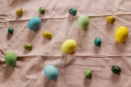 Happy Easter! Rustic easter still life. Natural painted eggs and cherry petals on pink linen fabric....
