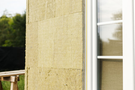 Facade insulation with mineral wool, thermal improvement and energy saving. Modern farmhouse...