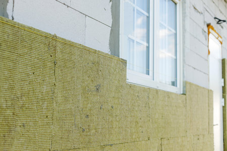 Facade insulation with mineral wool, thermal improvement and energy saving. Modern farmhouse...
