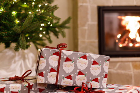 Merry Christmas! Stylish wrapped christmas gifts, christmas tree with festive lights and cozy...