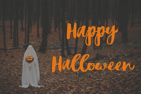 Happy Halloween! Happy Halloween text and spooky ghost holding glowing jack o lantern in moody dark autumn forest. Scary atmospheric halloween greeting card, handwritten signの写真素材