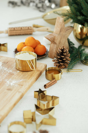 Making christmas gingerbread cookies in modern white kitchen. Gingerbread dough on wooden board,...