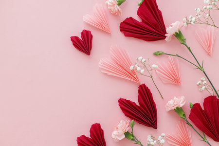 Valentines day flat lay. Stylish pink and red hearts composition with flowers on pink background, space for text. Happy Valentines day! Modern hearts paper cutouts. Love and mothers dayの写真素材