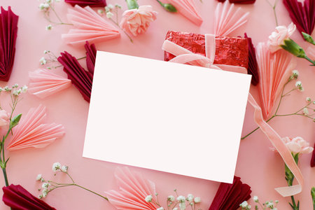 Valentines day card mockup, space for text. Empty greeting card, stylish pink and red hearts, flowers on pink background. Happy Valentines day! Love and mother's dayの写真素材