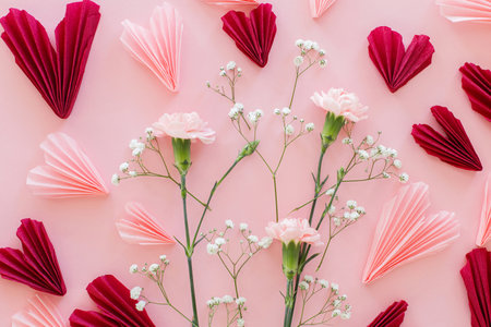 Valentines day flat lay. Stylish pink and red hearts composition with flowers on pink background. Happy Valentines day! Modern hearts paper cutouts. Love and mothers dayの写真素材