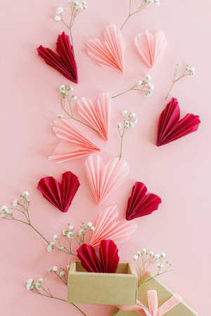 Happy Valentine's day ! Stylish pink and red hearts, flowers and gift box flat lay on pink background. Valentines hearts paper cutouts and craft box. Love and mother's dayの写真素材