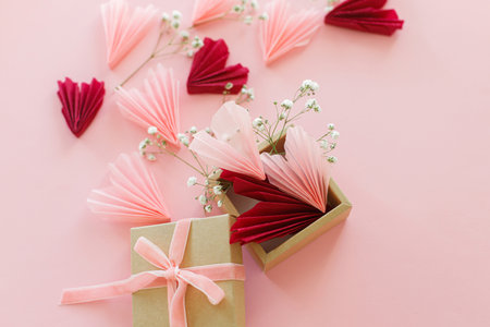 Happy Valentine's day ! Stylish pink and red hearts, flowers and gift box flat lay on pink background. Valentines hearts paper cutouts and craft box. Love and mother's dayの写真素材