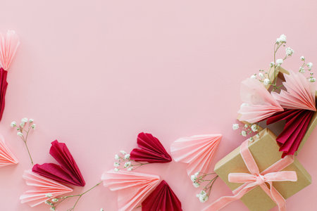 Happy Valentine's day ! Stylish pink and red hearts, flowers and gift box flat lay on pink background, space for text. Valentines hearts paper cutouts and craft box. Love and mother's dayの写真素材