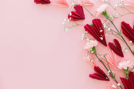 Valentines day flat lay. Stylish pink and red hearts composition with flowers on pink background, space for text. Happy Valentines day! Modern hearts paper cutouts. Love and mothers dayの写真素材