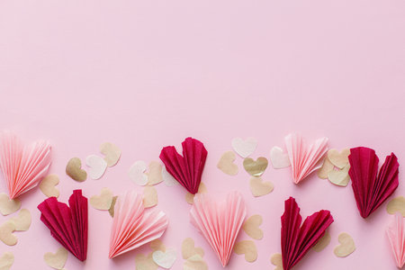 Valentine flat lay. Stylish pink and red hearts border on pink background. Happy Valentines day and happy mothers day. Greeting card and banner template, space for textの写真素材