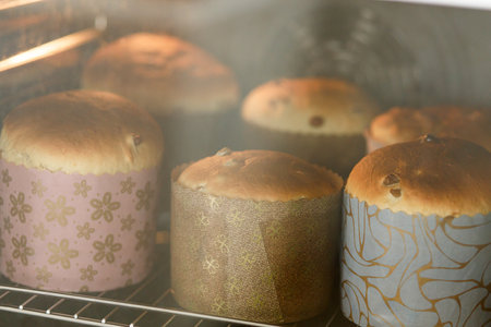 Baking easter traditional bread in oven. Raw dough in baking forms for making homemade easter cake....