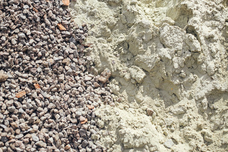Gravel and sand pile close up. Gravel stones and sand for concrete at construction site, process of house building. Building materialsの写真素材