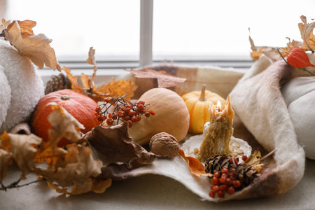 Happy Thanksgiving. Pumpkins, autumn leaves, candle and woolen scarf on windowsill. Autumn hygge still life. Hello fallの写真素材