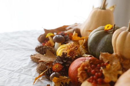 Happy Thanksgiving. Pumpkins, fall leaves and flowers, berries and pine cones on linen cloth, space for text. Autumn banner. Fall harvest backgroundの写真素材