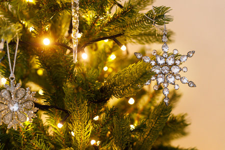 Beautiful decorated christmas tree with glass snowflake, vintage baubles and lights. Winter holidays preparation. Atmospheric magical eve. Stylish christmas ornament on tree close upの写真素材