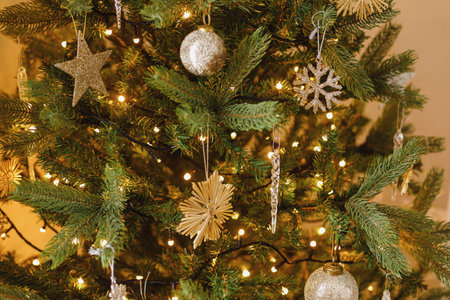 Merry Christmas! Beautiful decorated christmas tree with vintage baubles,  glass snowflake and golden lights. Winter holidays preparation. Stylish christmas ornaments on treeの写真素材
