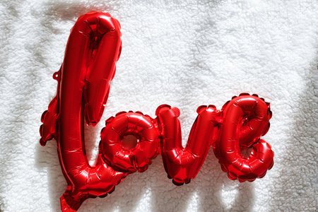 Valentines flat lay. Stylish red love shaped balloon on soft white background in sunlight. Happy valentines day. Love bannerの写真素材