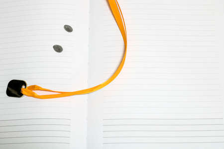 Open pages of a close-up notebook with a funny bookmarkの写真素材