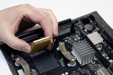 Repairing the computers processor, the hand installs the processor