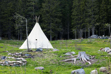 Summer wigwam in an open area near the forest in the afternoon or in the morning.の写真素材