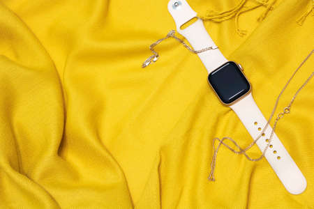 Flat lay of a clock on a bright yellow background. new technologiesの写真素材