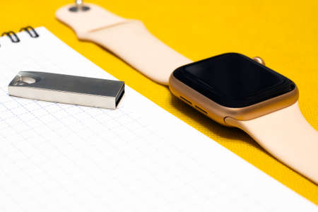 Smart watch and flash drive on a white sheet of paper. Modern new devices, gadgets
