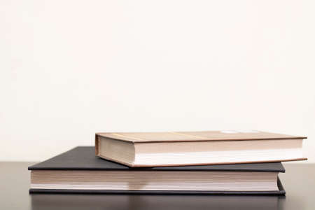 Books in colored covers on a dark wooden table. Copy space, knowledge concept.の写真素材