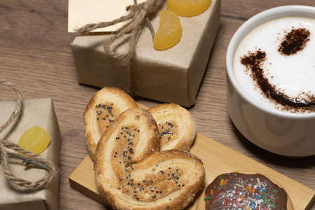Coffee smile and dessert, cookies and gift boxes on the table.