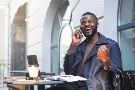 Excited businessman just landed a deal with a company over the phone.の写真素材