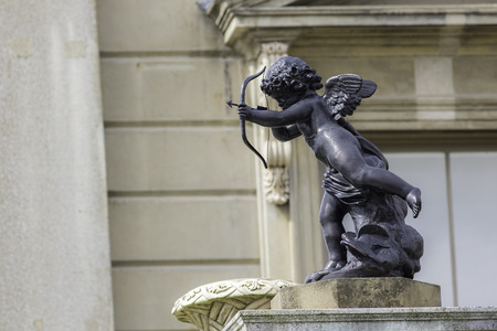 A traditional classical statue of a cherub firing an arrow. A symbol of love.の写真素材