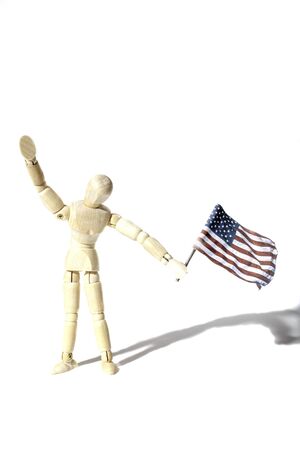Anonymous American citizen waving a USA flag, Represented by a faceless artist mannequin doll. Connotations of citizenship and illegal immigration etc. Shot against a white background with shadow and provinding text space.の写真素材