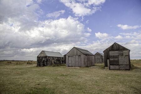 Desolate storage sheds. Abandoned wooden shacks once used as coastal garages and to store small fishing boats. の写真素材