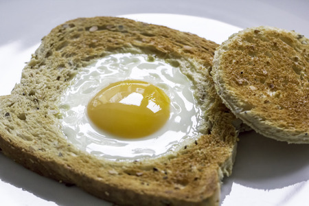 Novelty healthy breakfast meal of egg in toast. Egg fried in the centre of a slice of toast also...