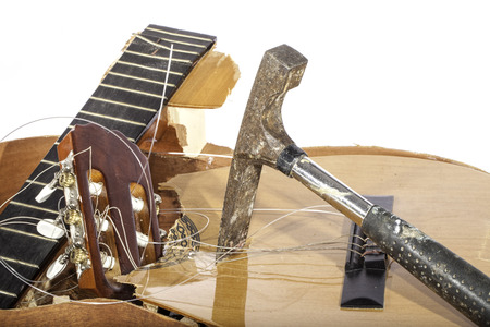An acoustic guitar in pieces. Smashed with a masonry hammer by its frustrated guitarist owner. No more music scales.の写真素材